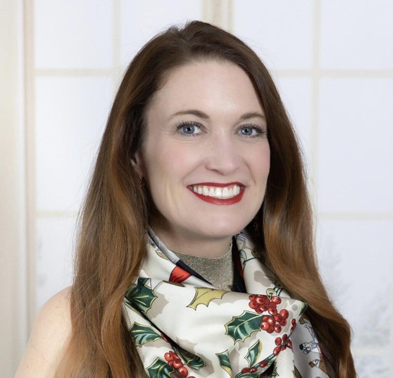 Sarah Wiley smiling in front of light background.